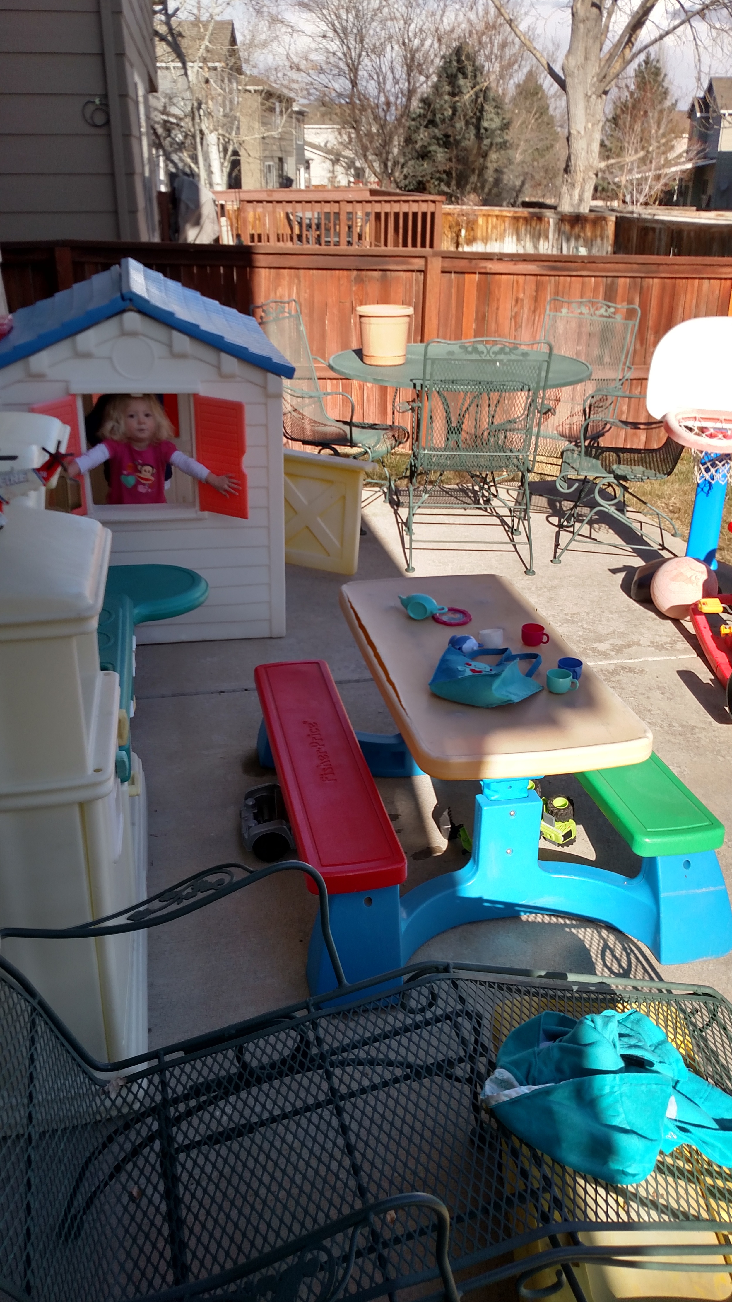 Child playing outdoors in a backyard play area