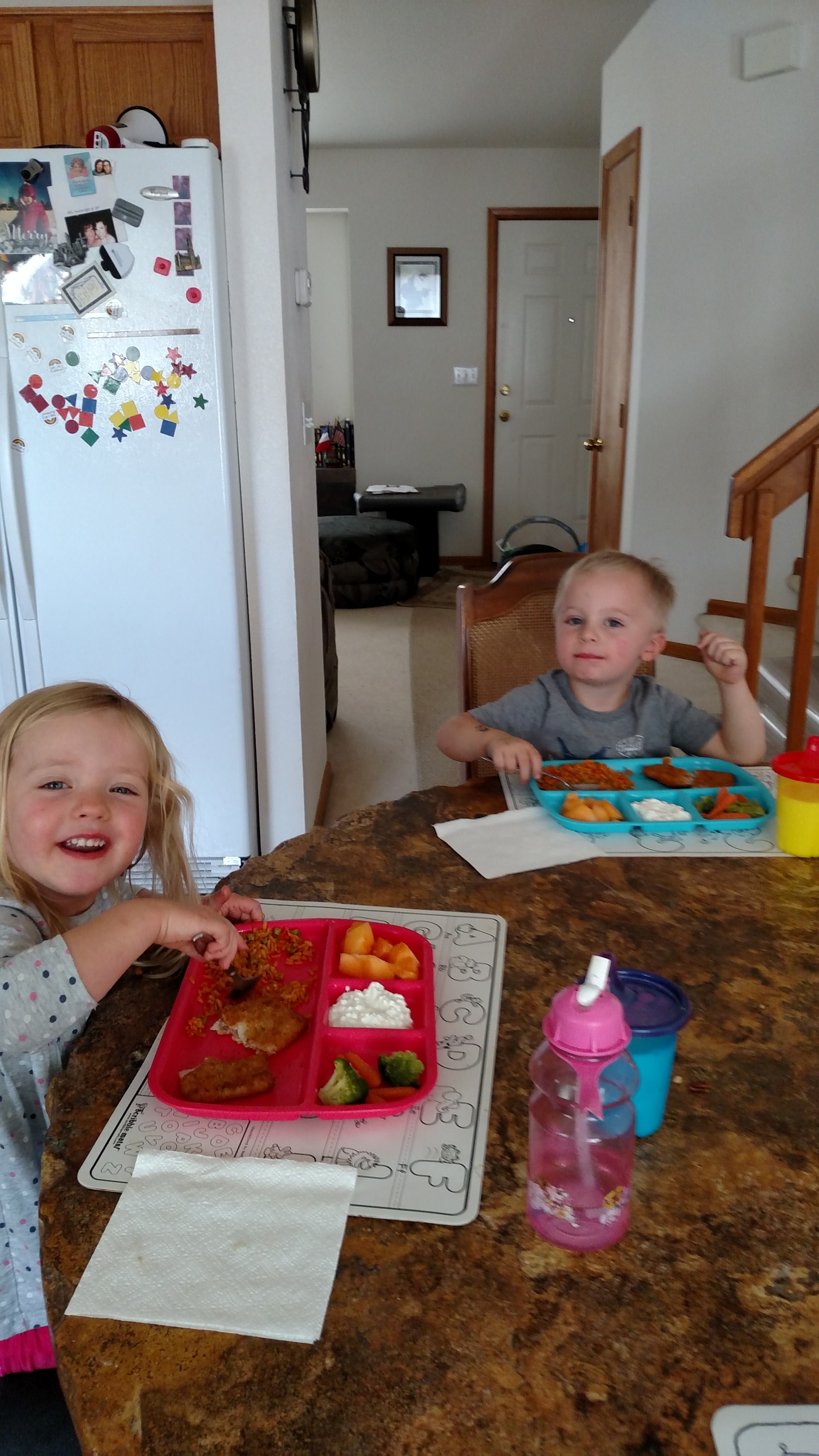 Children eating a meal together at a table