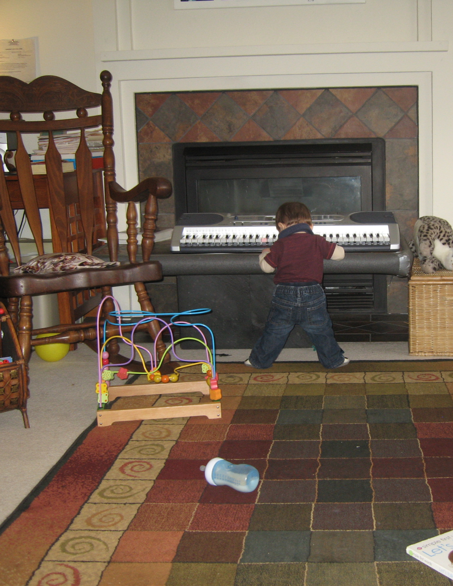 Child playing an electronic keyboard in a home childcare setting